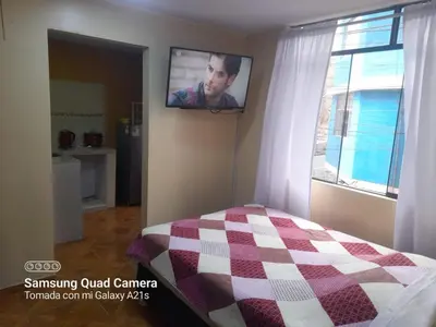 a bedroom with a bed and a tv on the wall at 202 Comfy Apt WiFi kitchen SmartTV Central at Callao in Lima