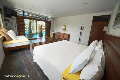 a bedroom with a large white bed and a window at HOTEL RUSTICA PACHACAMAC in Lima