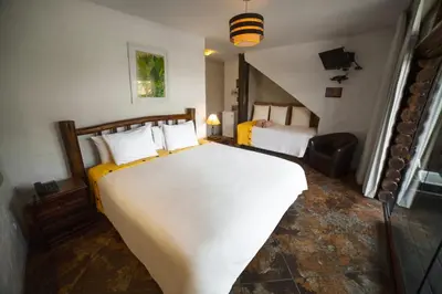 a bedroom with a large white bed in a room at HOTEL RUSTICA PACHACAMAC in Lima