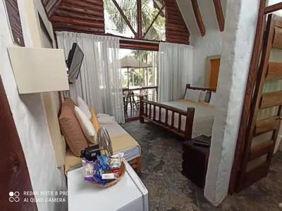 a room with two beds and a kitchen with a sink at HOTEL RUSTICA PACHACAMAC in Lima