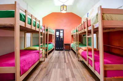a room with four bunk beds in a hostel at Dragonfly Hostels Cusco in Cusco