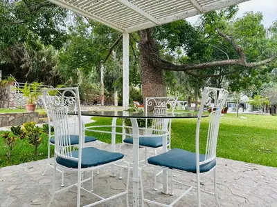 a table and chairs sitting under a canopy at Hotel Los Palomos in Lunahuaná