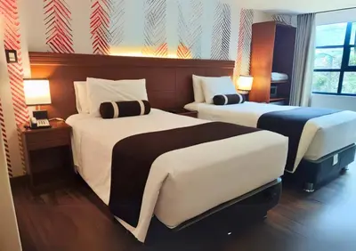 a hotel room with two beds in a room at Hotel Ferré Machu Picchu in Machu Picchu
