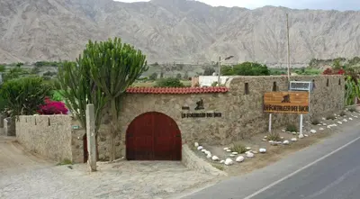 a building on the side of a road at La Fortaleza del Inca in Lunahuaná