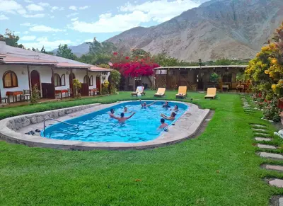 a group of people in a swimming pool in a yard at La Fortaleza del Inca in Lunahuaná