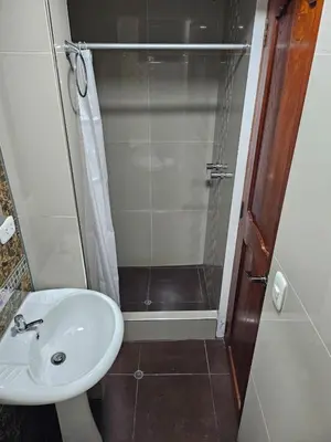 a bathroom with a sink and a shower at Hotel Horizonte in Machu Picchu
