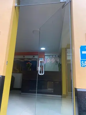 a glass door in a building with a room at Hotel Horizonte in Machu Picchu