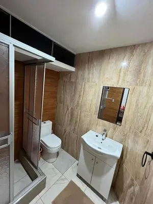 a bathroom with a toilet and a sink at Palmeras house in Ica
