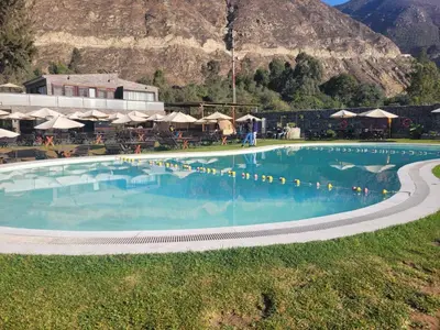 a large swimming pool with a mountain in the background at HOTEL RUSTICA SANTA EULALIA in Lima