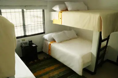 a bedroom with two bunk beds and a small bed at HOTEL RUSTICA SANTA EULALIA in Lima