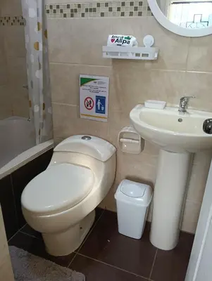 a small bathroom with a toilet and a sink at Hotel and Country House Valle Sagrado de los Incas in Huaran