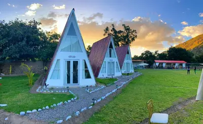 a group of modular houses in a field at Vallecito Lodge in Muyurina