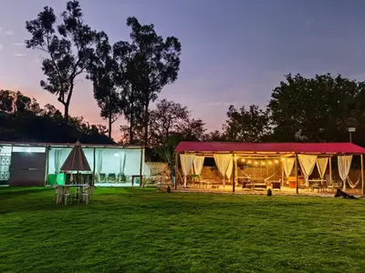 a tent in a field next to a field at Vallecito Lodge in Muyurina
