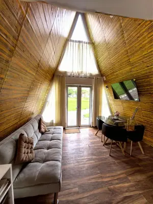 a living room with a couch and a table at Vallecito Lodge in Muyurina