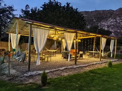 a pavilion with tables and chairs in a backyard at Vallecito Lodge in Muyurina