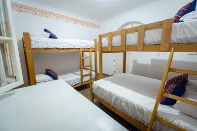 a room with three bunk beds and a window at Casa Águila y Cóndor Miraflores in Lima