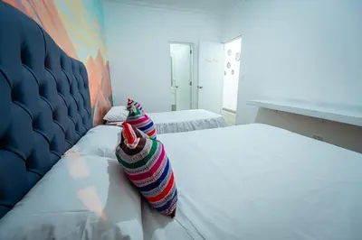 a bedroom with two colorful pillows on a bed at Casa Águila y Cóndor Miraflores in Lima