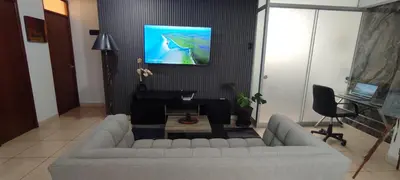 a living room with a couch and a tv on a wall at Sumaq Home Lima Airport in Lima