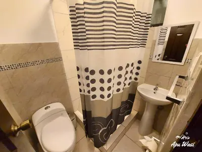 a bathroom with a toilet and a sink at Apu Wasi in Cusco
