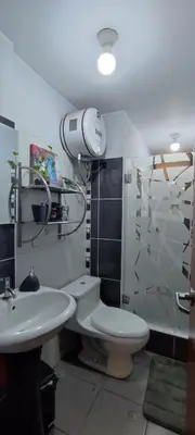 a bathroom with a toilet and a sink and a shower at Sumaq AirPort in Lima