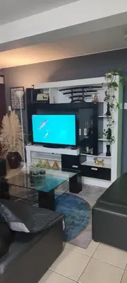 a living room with a couch and a tv at Sumaq AirPort in Lima