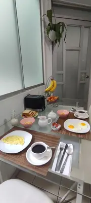 a counter with plates and utensils on a table at Sumaq AirPort in Lima