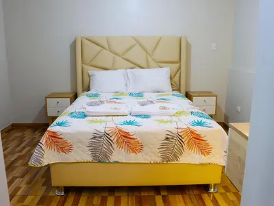 a bed with a colorful comforter on it in a bedroom at Paloma House in Lima