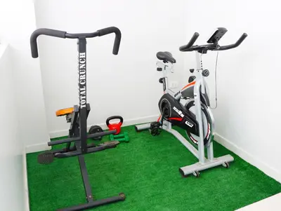 a gym with two exercise bikes and a treadmill at Paloma House in Lima