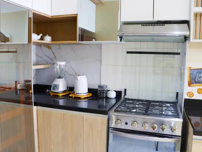 a kitchen with a stove and a blender on a counter at Paloma House in Lima