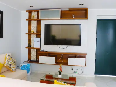 a living room with a flat screen tv on a wall at Paloma House in Lima