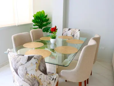 a dining room table with chairs and a glass table at Paloma House in Lima