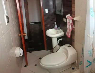 a bathroom with a toilet and a sink at WaskarWasi in Cusco