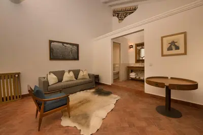 a living room with a couch and a table at Casa Clara by Ananay Hotels in Cusco