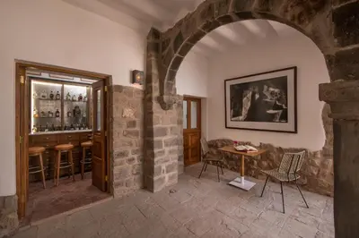 an archway in a room with a table and a bar at Casa Clara by Ananay Hotels in Cusco