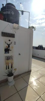 a white door on top of a roof at Lima Airport Sumaq Home in Lima