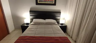 a bedroom with a bed with two lamps on both sides at Lima Airport Sumaq Home in Lima
