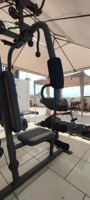 a gym with chairs under an umbrella at Lima Airport Sumaq Home in Lima