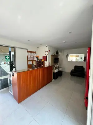 a waiting room with a counter in a room at Hotel JOMA in San Vicente de Cañete