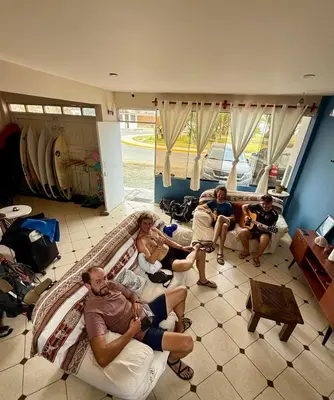a group of people sitting on a couch in a living room at Casa mar surfhouse in Punta Hermosa