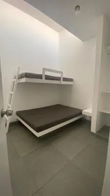 a room with two bunk beds in a room at Casa de Playa frente al mar en Chocalla, Asia in Asia