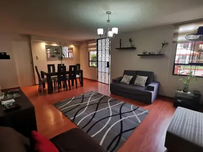 a living room with a couch and a table at Amplio, y confortable departamento en San Miguel in Lima