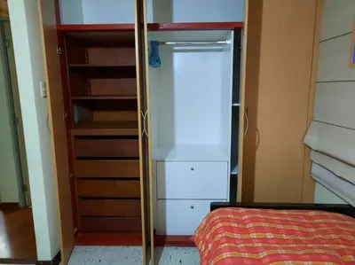 a room with a closet with a white refrigerator at Amplio, y confortable departamento en San Miguel in Lima