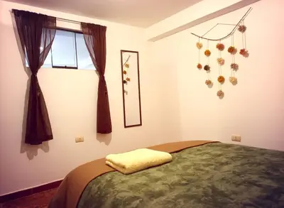 a bedroom with a bed and a window at Cuesta del Inka in Cusco