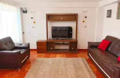 a living room with two couches and a flat screen tv at Cuesta del Inka in Cusco