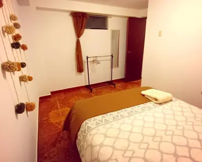 a bedroom with a bed in a room at Cuesta del Inka in Cusco