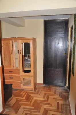a room with a wooden door and a wooden floor at Hostal Goya Andina in Cusco