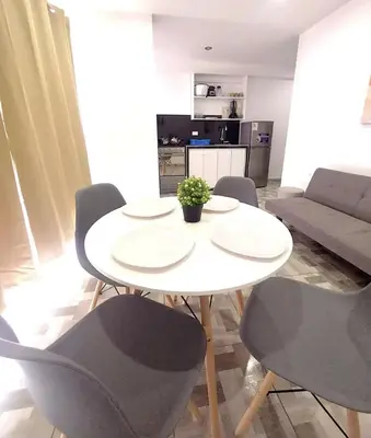 a white table and chairs in a living room at Miel de Luna in Cerro Azul
