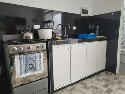 a kitchen with a stove and a counter top at Miel de Luna in Cerro Azul