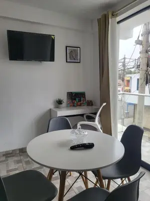 a white table and chairs in a room with a window at Miel de Luna in Cerro Azul
