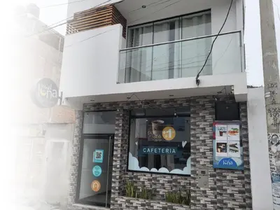 a facade of a coffee shop with a window at Miel de Luna in Cerro Azul